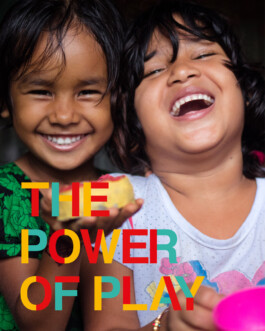 A photo of two children laughing in a Play Lab in Bangladesh with a text overlay that reads