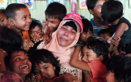  Rohingya refugee children in a Humanitarian Play Lab in Cox's Bazar, Bangladesh hug their Play Leader